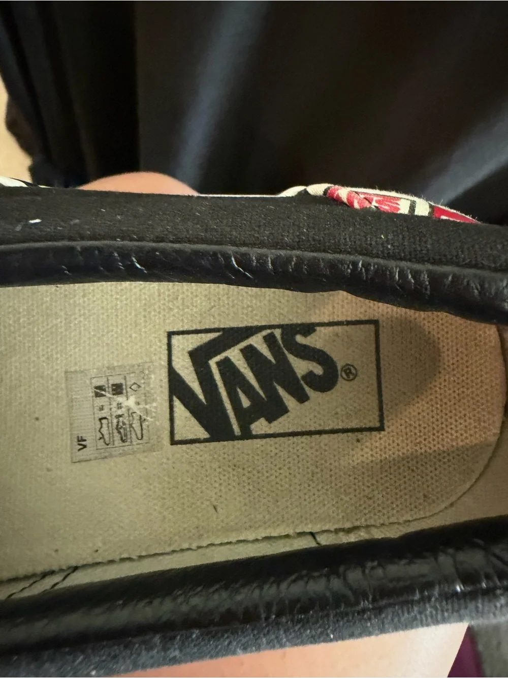 Vans Slip-On Sneakers in Black, White & Red Logo Print